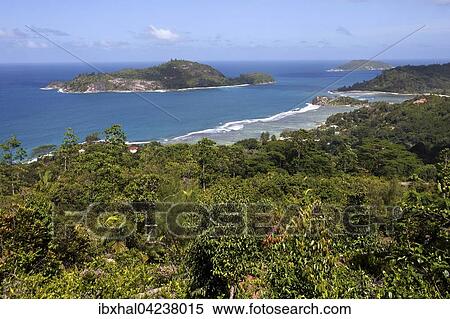 Views of coast and sea at Port Glaud, Ile Therese rear left, Mahe Island, Seychelles, Africa View Large Photo Image Stock Photography - Views of coast and sea at Port Glaud, Ile Therese rear left, Mahe Island, Seychelles, Africa. Fotosearch