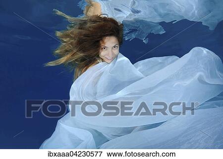 Woman in a long white dress under water, underwater fashion in the pool, Odessa, Ukraine, Europe View Large Photo Image Stock Photo - Woman in a long white dress under water, underwater fashion in the pool, Odessa, Ukraine, Europe. Fotosearch