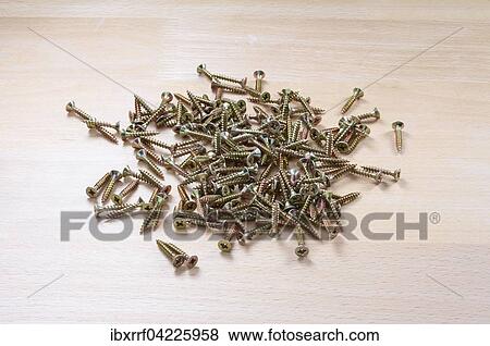 Stock Photo - Wood screws on a wooden table. Fotosearch