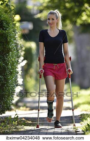 Young woman with crutches, walking with a foot injury, with a plaster splint, Germany, Europe View Large Photo Image Stock Photo - Young woman with crutches, walking with a foot injury, with a plaster splint, Germany, Europe. Fotosearch