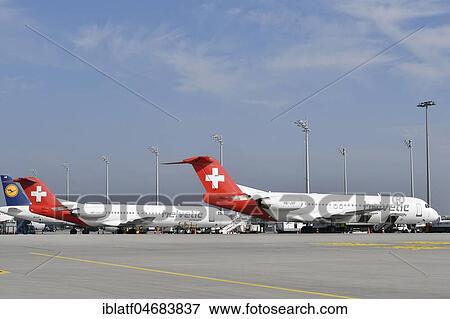 2x Helvetic Airways, Fokker, F100, Position, Apron East, Munich Airport, Upper Bavaria, Germany, Europe View Large Photo Image Stock Photo - 2x Helvetic Airways, Fokker, F100, Position, Apron East, Munich Airport, Upper Bavaria, Germany, Europe. Fotosearch
