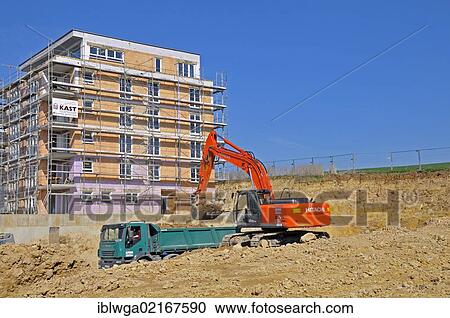Stock Image - A building pit is being excavated, earth works, construction of an apartment building in Ulm, Baden-Wuerttemberg, Germany, Europe, PublicGround, Europe. Fotosearch