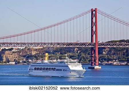 A cruise ship under the Ponte do 25 de Abril bridge, at the mouth of the Rio Tejo River in the Atlantic Ocean in the district of Belem, Lisbon, Portugal, Europe View Large Photo Image Stock Image - A cruise ship under the Ponte do 25 de Abril bridge, at the mouth of the Rio Tejo River in the Atlantic Ocean in the district of Belem, Lisbon, Portugal, Europe. Fotosearch