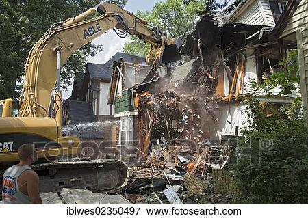 Stock Photo - A fire-damaged and vacant home in the Morningside neighborhood is demolished, Detroit, Michigan, USA, North America. Fotosearch