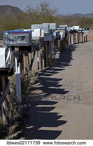 Stock Photo - A long row of mailboxes are lined up along a dirt road in the desert west of Tucson, Three Points, Arizona, USA, North America. Fotosearch