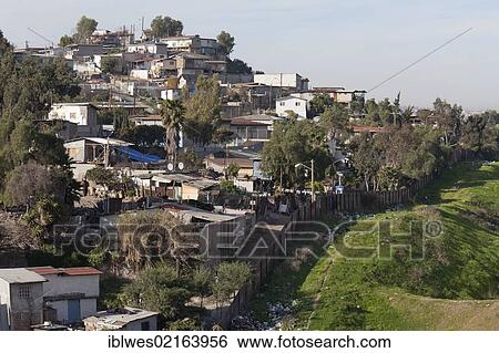 Stock Photograph - A neighborhood in Tijuana, Mexico, behind the fence that separates the United States and Mexico, San Ysidro, California, USA, North America. Fotosearch