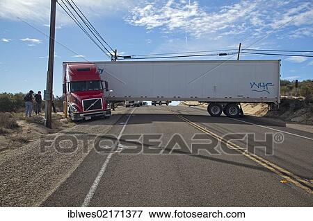 A tractor-trailer is stuck in soft sand and wedged between utility equipment, blocking traffic on California Highway 94, after the driver made an ill-advised decision to turn around on the narrow road, Campo, California, USA, North America View Large Photo Image Stock Photo - A tractor-trailer is stuck in soft sand and wedged between utility equipment, blocking traffic on California Highway 94, after the driver made an ill-advised decision to turn around on the narrow road, Campo, California, USA, North America. Fotosearch