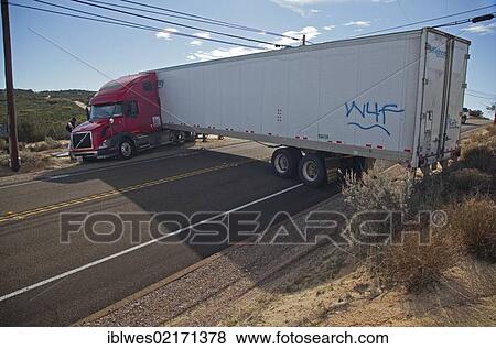 A tractor-trailer is stuck in soft sand and wedged between utility equipment, blocking traffic on California Highway 94, after the driver made an ill-advised decision to turn around on the narrow road, Campo, California, USA, North America View Large Photo Image Stock Photo - A tractor-trailer is stuck in soft sand and wedged between utility equipment, blocking traffic on California Highway 94, after the driver made an ill-advised decision to turn around on the narrow road, Campo, California, USA, North America. Fotosearch
