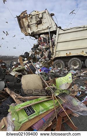 Stock Image - A truck dumps garbage at St. Clair County's Smith's Creek Landfill; landfill operators collect methane from decaying refuse and burn it to generate electricity, Smith's Creek, Michigan, USA, North America. Fotosearch