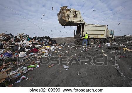 Stock Photo - A truck dumps garbage at St. Clair County's Smith's Creek Landfill; landfill operators collect methane from decaying refuse and burn it to generate electricity, Smith's Creek, Michigan, USA, North America. Fotosearch