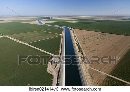 Aerial view of farmland in Central Valley with an irrigation canal which is part of California's Aqueduct, a system of canals, tunnels and pipes, which leads water from the Sierra Nevada of northern and central California to southern California,... View Large Photo Image Stock Image - Aerial view of farmland in Central Valley with an irrigation canal which is part of California's Aqueduct, a system of canals, tunnels and pipes, which leads water from the Sierra Nevada of northern and central California to southern California,.... Fotosearch
