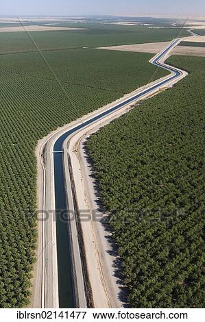 Aerial view of farmland in Central Valley with an irrigation canal which is part of California's Aqueduct, a system of canals, tunnels and pipes, which leads water from the Sierra Nevada of northern and central California to southern California,... View Large Photo Image Stock Photo - Aerial view of farmland in Central Valley with an irrigation canal which is part of California's Aqueduct, a system of canals, tunnels and pipes, which leads water from the Sierra Nevada of northern and central California to southern California,.... Fotosearch