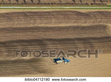 Stock Image - Aerial view, Tractor with slurry tanker on a field extends slurry, slurry application, Ruhr Area, North Rhine-Westphalia, Germany, Europe. Fotosearch