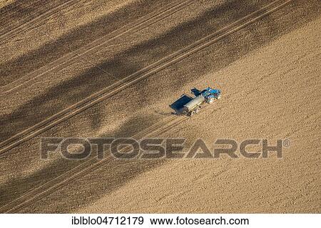 Stock Photo - Aerial view, Tractor with slurry tanker on a field extends slurry, slurry application, Ruhr Area, North Rhine-Westphalia, Germany, Europe. Fotosearch