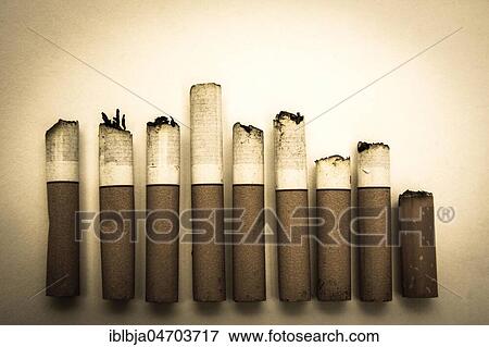 Stock Photo - Alignment of nine cigarette butts. Fotosearch