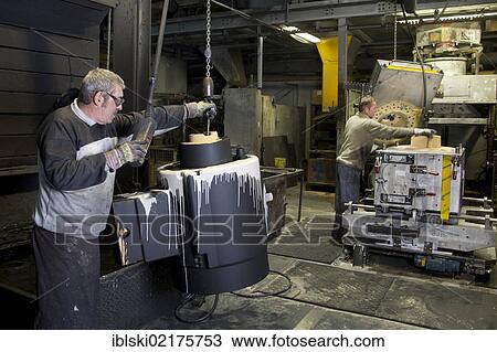 An employee of Luitpoldhuette AG, a foundry that specializes in the casting of engine blocks, motor parts and refrigeration compressors, making a core for mould casting, in Amberg, Bavaria, Germany, Europe View Large Photo Image Stock Image - An employee of Luitpoldhuette AG, a foundry that specializes in the casting of engine blocks, motor parts and refrigeration compressors, making a core for mould casting, in Amberg, Bavaria, Germany, Europe. Fotosearch