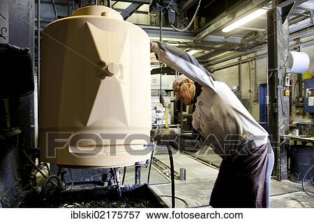 An employee of Luitpoldhuette AG, a foundry that specializes in the casting of engine blocks, motor parts and refrigeration compressors, making a core for mould casting, in Amberg, Bavaria, Germany, Europe View Large Photo Image Stock Photo - An employee of Luitpoldhuette AG, a foundry that specializes in the casting of engine blocks, motor parts and refrigeration compressors, making a core for mould casting, in Amberg, Bavaria, Germany, Europe. Fotosearch