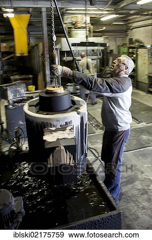 An employee of Luitpoldhuette AG, a foundry that specializes in the casting of engine blocks, motor parts and refrigeration compressors, making a core for mould casting, in Amberg, Bavaria, Germany, Europe View Large Photo Image Stock Photo - An employee of Luitpoldhuette AG, a foundry that specializes in the casting of engine blocks, motor parts and refrigeration compressors, making a core for mould casting, in Amberg, Bavaria, Germany, Europe. Fotosearch