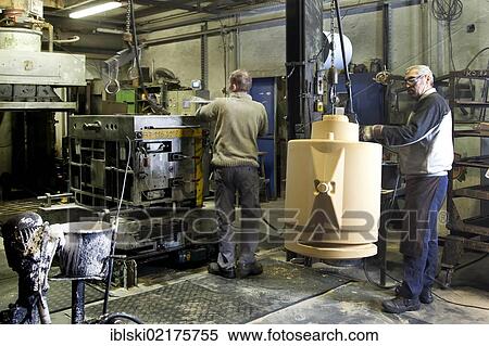 An employee of Luitpoldhuette AG, a foundry that specializes in the casting of engine blocks, motor parts and refrigeration compressors, making a core for mould casting, in Amberg, Bavaria, Germany, Europe View Large Photo Image Stock Photography - An employee of Luitpoldhuette AG, a foundry that specializes in the casting of engine blocks, motor parts and refrigeration compressors, making a core for mould casting, in Amberg, Bavaria, Germany, Europe. Fotosearch
