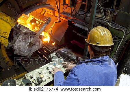 An employee of the Luitpoldhuette AG, a foundry that specializes in the casting of engine blocks, motor parts and refrigeration compressors, pouring molten metal from a ladle into a casting mould, in Amberg, Bavaria, Germany, Europe View Large Photo Image Picture - An employee of the Luitpoldhuette AG, a foundry that specializes in the casting of engine blocks, motor parts and refrigeration compressors, pouring molten metal from a ladle into a casting mould, in Amberg, Bavaria, Germany, Europe. Fotosearch