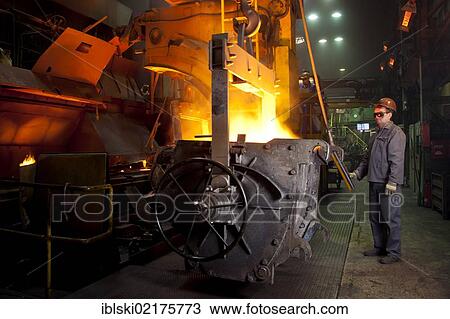 An employee of the Luitpoldhuette AG, a foundry that specializes in the casting of engine blocks, motor parts and refrigeration compressors, setting the casting ladle for the automated casting process, in Amberg, Bavaria, Germany, Europe View Large Photo Image Stock Image - An employee of the Luitpoldhuette AG, a foundry that specializes in the casting of engine blocks, motor parts and refrigeration compressors, setting the casting ladle for the automated casting process, in Amberg, Bavaria, Germany, Europe. Fotosearch