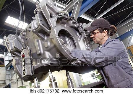 An employee of the Luitpoldhuette AG, a foundry that specializes in the casting of engine blocks, motor parts and refrigeration compressors, controlling a cast rear axle, in Amberg, Bavaria, Germany, Europe View Large Photo Image Stock Image - An employee of the Luitpoldhuette AG, a foundry that specializes in the casting of engine blocks, motor parts and refrigeration compressors, controlling a cast rear axle, in Amberg, Bavaria, Germany, Europe. Fotosearch