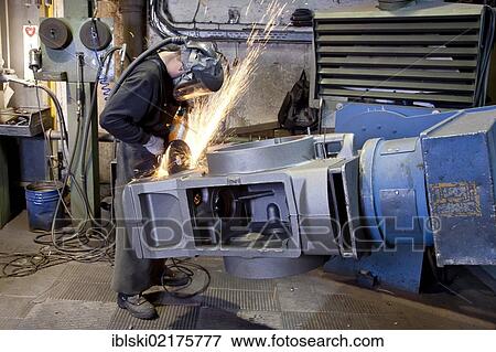 An employee of the Luitpoldhuette AG, a foundry that specializes in the casting of engine blocks, motor parts and refrigeration compressors, trimming a cast rear axle with an angle grinder, in Amberg, Bavaria, Germany, Europe View Large Photo Image Stock Photo - An employee of the Luitpoldhuette AG, a foundry that specializes in the casting of engine blocks, motor parts and refrigeration compressors, trimming a cast rear axle with an angle grinder, in Amberg, Bavaria, Germany, Europe. Fotosearch