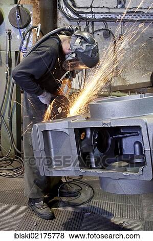 An employee of the Luitpoldhuette AG, a foundry that specializes in the casting of engine blocks, motor parts and refrigeration compressors, trimming a cast rear axle with an angle grinder, in Amberg, Bavaria, Germany, Europe View Large Photo Image Stock Photo - An employee of the Luitpoldhuette AG, a foundry that specializes in the casting of engine blocks, motor parts and refrigeration compressors, trimming a cast rear axle with an angle grinder, in Amberg, Bavaria, Germany, Europe. Fotosearch