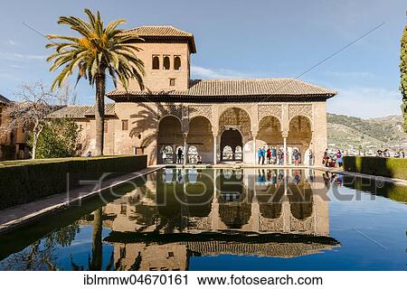 Stock Image - Antique Building El Partal with pool and palm trees, Alhambra, city castle on Sabikah Hill, Grenada, Andalusia, Spain, Central America. Fotosearch