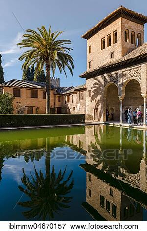 Stock Photo - Antique Building El Partal with pool and palm trees, Alhambra, city castle on Sabikah Hill, Grenada, Andalusia, Spain, Central America. Fotosearch
