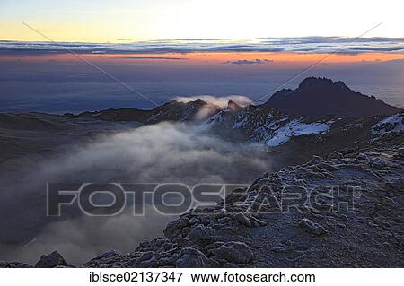 At sunrise, clouds in the crater of Mount Kilimanjaro, Tanzania, Africa View Large Photo Image Stock Photo - At sunrise, clouds in the crater of Mount Kilimanjaro, Tanzania, Africa. Fotosearch
