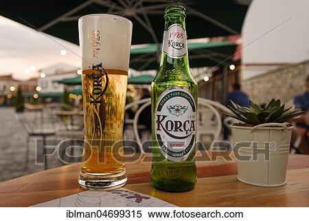 Stock Photography - Beer glass and beer bottle on table, Korca beer, Korca, Korça, Albania, Europe. Fotosearch