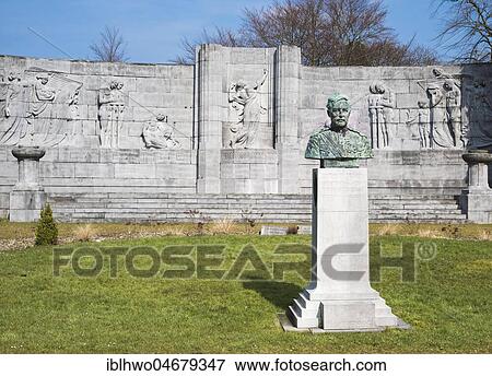 Stock Photo - Belgian military cemetery, memorial wall with reliefs, bust of King Albert I, conquest of Liège was the first major offensive operation, First World War, Liège, Wallonia, Belgium, Europe. Fotosearch