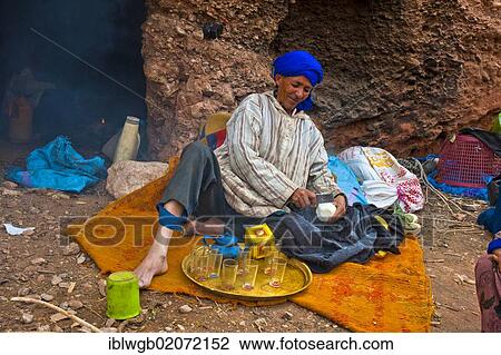 Berber man wearing a blue turban using a metal blade to shave off pieces of sugar for his tea, nomadic cave dweller, Dades Valley, southern Morocco, Morocco, Africa View Large Photo Image Stock Image - Berber man wearing a blue turban using a metal blade to shave off pieces of sugar for his tea, nomadic cave dweller, Dades Valley, southern Morocco, Morocco, Africa. Fotosearch