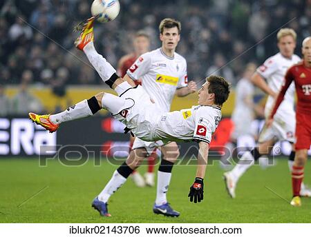 Bicycle kick by Patrick Herrmann, scorer of two goals, Gladbach, VfL Borussia Moenchengladbach - FC Bavaria Munich, 3: 1, Borussia Park, Monchengladbach, North Rhine-Westphalia, Germany, Europe View Large Photo Image Stock Photograph - Bicycle kick by Patrick Herrmann, scorer of two goals, Gladbach, VfL Borussia Moenchengladbach - FC Bavaria Munich, 3: 1, Borussia Park, Monchengladbach, North Rhine-Westphalia, Germany, Europe. Fotosearch