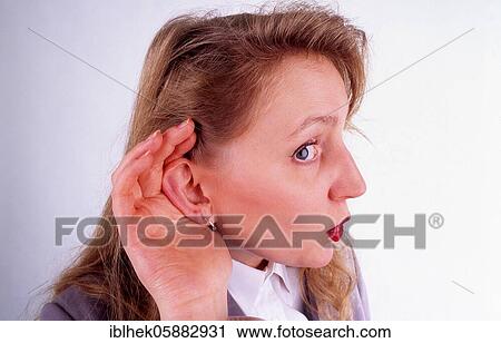 Stock Image - Blonde woman listening, Berlin, Germany, Europe. Fotosearch
