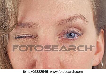 Stock Photograph - Blonde woman, wink, flirt, Berlin, Germany, Europe. Fotosearch