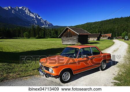 BMW 2002 tii, classic car on Eibseestraße, in the back Zugspitze, Grainau, Upper Bavaria, Bavaria, Germany, Europe View Large Photo Image Stock Photo - BMW 2002 tii, classic car on Eibseestraße, in the back Zugspitze, Grainau, Upper Bavaria, Bavaria, Germany, Europe. Fotosearch