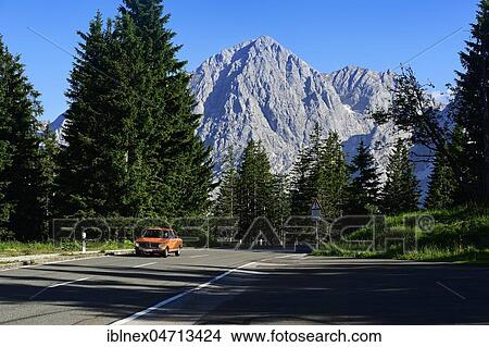 Picture - BMW 2002 tii, classic car on the Rossfeld panorama road, in the back the summit of the Hohe Göll, Berchtesgaden, Upper Bavaria, Bavaria, Germany, Europe. Fotosearch