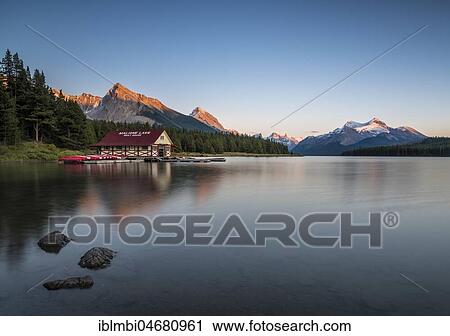 Stock Image - Boathouse with canoes on the shores of Maligne Lake, sunset, Jasper National Park, Rocky Mountains, Alberta, Canada, North America. Fotosearch