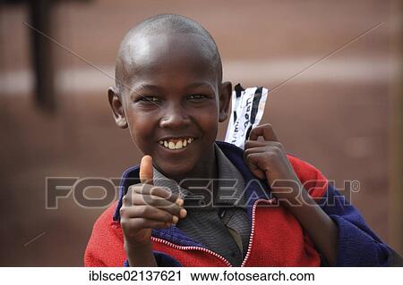 Boy, smiling, holding up his thumb, portrait, Tanzania, Africa View Large Photo Image Stock Image - Boy, smiling, holding up his thumb, portrait, Tanzania, Africa. Fotosearch