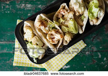 Stock Photography - Bread bags with roasted cauliflower, in box form. Fotosearch