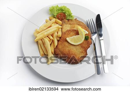 Breaded pork escalope Viennese style with lemon slice and French fries View Large Photo Image Picture - Breaded pork escalope Viennese style with lemon slice and French fries. Fotosearch