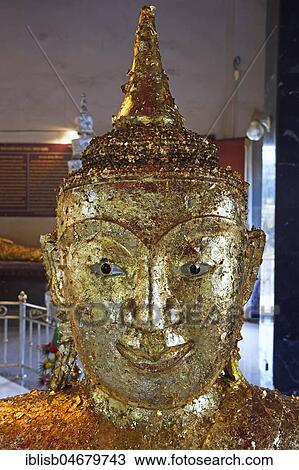 Stock Image - Buddha statue covered with gold leaf, Temple Wat Phra Thong, Phuket, Thailand, Asia. Fotosearch