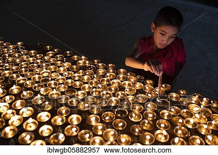 Buddhist children's monk, novice lights butter lamps, Lamayuru Monastery, Ladakh, India, Asia View Large Photo Image Stock Photo - Buddhist children's monk, novice lights butter lamps, Lamayuru Monastery, Ladakh, India, Asia. Fotosearch