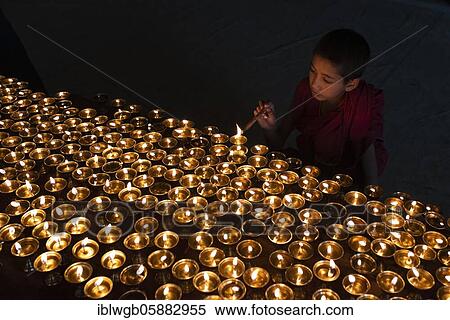 Stock Photography - Buddhist children's monk, novice lights butter lamps, Lamayuru Monastery, Ladakh, India, Asia. Fotosearch