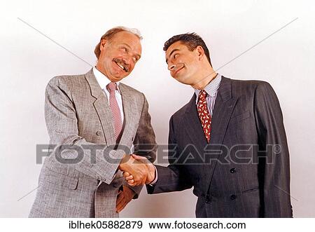 Stock Photo - Businessmen shake hands, funny, Berlin, Germany, Europe. Fotosearch