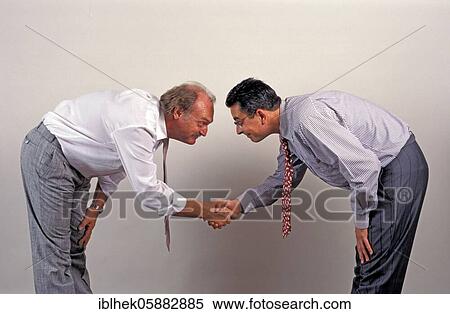 Businessmen shake hands, funny, deep bow, Berlin, Germany, Europe View Large Photo Image Stock Photography - Businessmen shake hands, funny, deep bow, Berlin, Germany, Europe. Fotosearch