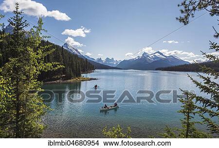 Canoeist on Maligne Lake, behind it Queen Elizabeth Ranges, Jasper National Park, Rocky Mountains, Alberta, Canada, North America View Large Photo Image Picture - Canoeist on Maligne Lake, behind it Queen Elizabeth Ranges, Jasper National Park, Rocky Mountains, Alberta, Canada, North America. Fotosearch
