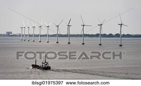 Stock Photo - Cargo ship sailing in front of an offshore wind farm in the Øresund outside Copenhagen, Denmark, Europe. Fotosearch